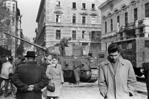 Old black-and-white photo of a tank and people on the streets of Budapest