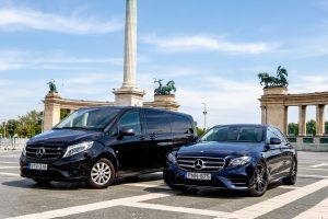 Two Mercedes vehicles standing in Heroe's Square, Budapest, Hungary